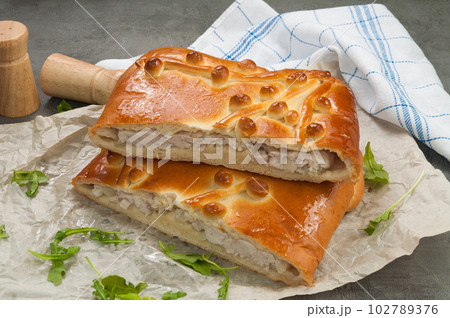 homemade chicken and onion pie decorated with arugula 102789376