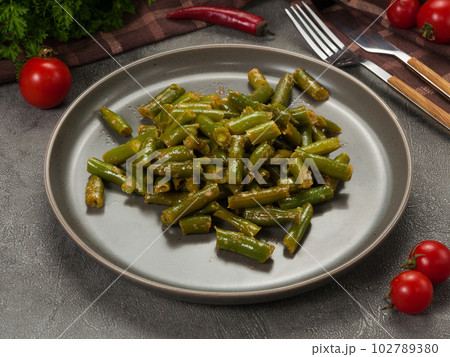 boiled string beans on a gray plate. vegetarian dish boiled string beans on a gray plate. vegetarian dish 102789380