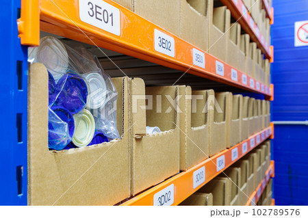 Boxes on racks in a warehouse of goods close-up. Boxes on racks in a warehouse of goods close-up. 102789576