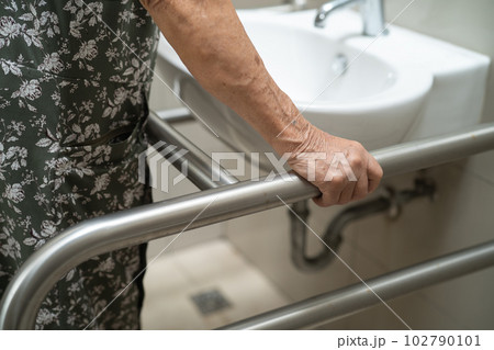 Asian elderly old lady woman patient use toilet bathroom handle security in nursing hospital, healthy strong medical concept. Asian elderly old lady woman patient use toilet bathroom handle security in nursing hospital, healthy strong medical concept. 102790101