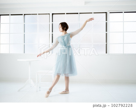 窓のある明るい室内でバレエの練習をする女性 102792228