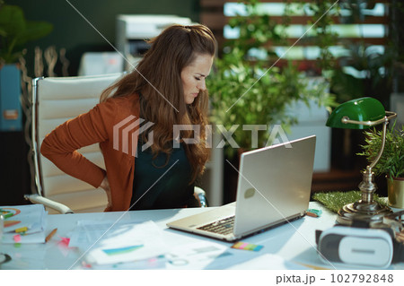 sad business owner woman in green office working with documents 102792848