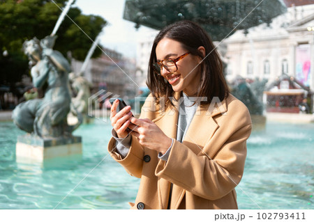 Woman in glasses using smartphone outdoor Woman in glasses using smartphone outdoor 102793411