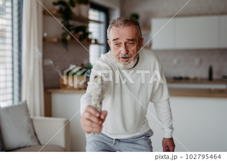 Senior man doing ritual with a sage. Senior man doing ritual with a sage. 102795464