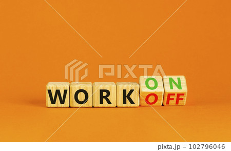 Work on or off symbol. Businessman turns wooden cubes and changes word Work off to Work on. Beautiful orange table orange background. Business and work on or off concept. Copy space. 102796046