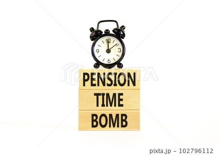 Pension time bomb symbol. Concept words Pension time bomb on wooden blocks on a beautiful white table white background. Black alarm clock. Business pension time bomb concept. Copy space. 102796112