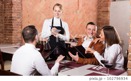 Adult female waiter writing down order 102796934