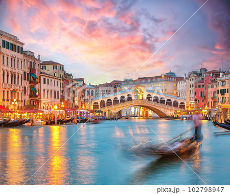 Stunning sunset and evening cityscape of Venice with famous Canal Grande and Rialto Bridge Stunning sunset and evening cityscape of Venice with famous Canal Grande and Rialto Bridge 102798947