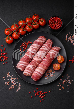 Raw minced meat wrapped in bacon with salt and spices or cevapcici 102799050