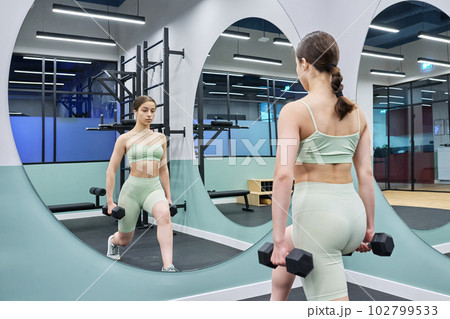 Teenage female doing sports workout in gym of an apartment complex 102799533