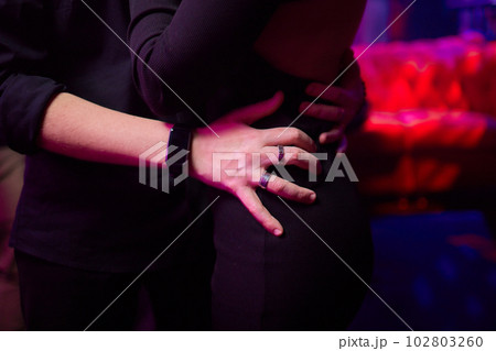 Close up of young couple hold hands talking sharing secrets showing love and care, husband and wife have tender close moment together, demonstrate support and understanding. 102803260