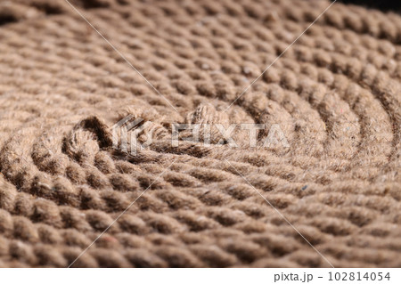 Rope made of cotton twisted into spiral lies on surface Rope made of cotton twisted into spiral lies on surface 102814054
