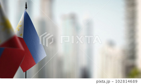 Small flags of the Philippines on an abstract blurry background 102814689