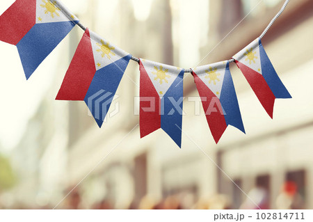 A garland of Philippines national flags on an abstract blurred background A garland of Philippines national flags on an abstract blurred background 102814711