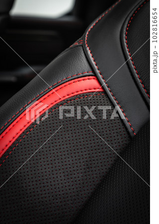 close-up black and red perforated leather car seat. Skin texture close-up black and red perforated leather car seat. Skin texture 102816654