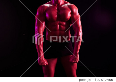 Man professional bodybuilder athlete naked torso in sports, isolated on multicolored background in neon light. Advertising, sports, active lifestyle, colored light, competition, challenge concept. Man professional bodybuilder athlete naked torso in sports, isolated on multicolored background in neon light. Advertising, sports, active lifestyle, colored light, competition, challenge concept. 102817466