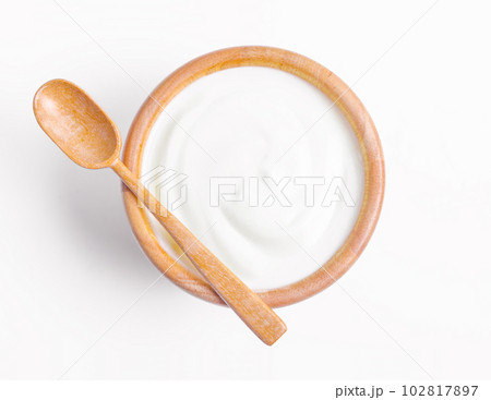 The Fresh greek yogurt in wooden bowl with wooden spoon on white background. Healthy breakfast. The Fresh greek yogurt in wooden bowl with wooden spoon on white background. Healthy breakfast. 102817897