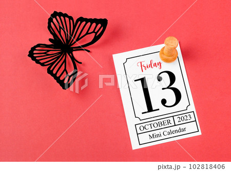 The Calendar Friday the 13th on mini calendar with black color butterfly paper on red background. 102818406