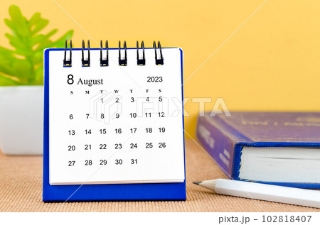 The August 2023 desk calendar with a book. 102818407