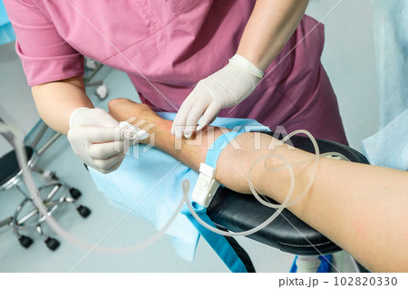 The doctor wipes the patient's hand with an alcohol solution 102820330