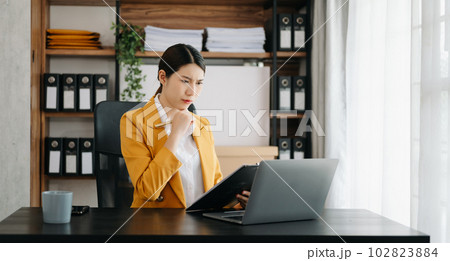 Business woman using tablet and laptop for doing math finance on an office desk, tax, report, accounting, statistics, and analytical research concept in office. Business woman using tablet and laptop for doing math finance on an office desk, tax, report, accounting, statistics, and analytical research concept in office. 102823884