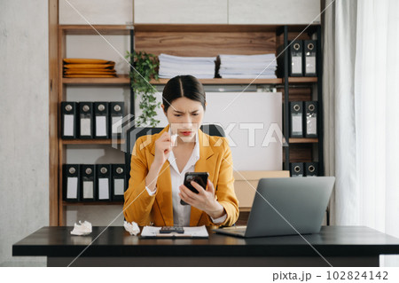 Business woman using tablet and laptop for doing math finance on an office desk, tax, report, accounting, statistics, and analytical research concept in office. Business woman using tablet and laptop for doing math finance on an office desk, tax, report, accounting, statistics, and analytical research concept in office. 102824142