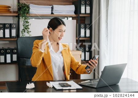 Business woman using tablet and laptop for doing math finance on an office desk, tax, report, accounting, statistics, and analytical research concept in office. Business woman using tablet and laptop for doing math finance on an office desk, tax, report, accounting, statistics, and analytical research concept in office. 102824144