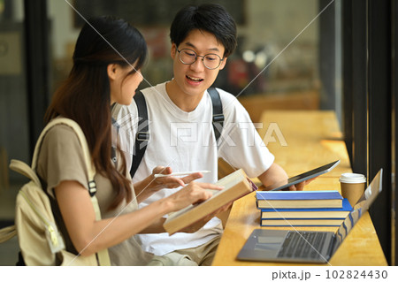 Image of university students collaborating on a project in campus. Education, Learning and technology concept Image of university students collaborating on a project in campus. Education, Learning and technology concept 102824430