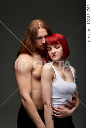 Happy sexy passionate young couple in love hugging in studio. Handsome muscular half-naked man and beautiful woman in lingerie. Love and passion. Happy sexy passionate young couple in love hugging in studio. Handsome muscular half-naked man and beautiful woman in lingerie. Love and passion. 102824769