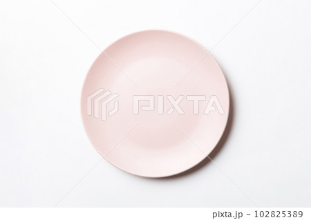 Top view of isolated of colored background empty round beige plate for food. Empty dish with space for your design Top view of isolated of colored background empty round beige plate for food. Empty dish with space for your design 102825389