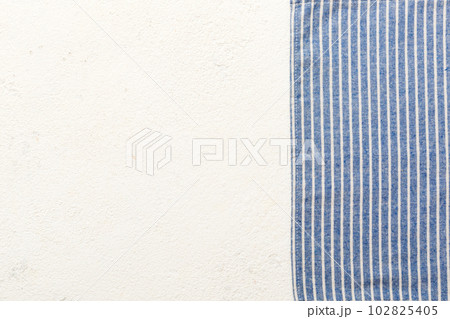 top view with blue kitchen napkin isolated on table background. Folded cloth for mockup with copy space, Flat lay. Minimal style 102825405