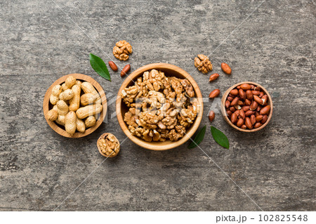 Walnut kernel halves, in a wooden bowl. Close-up, from above on colored background. Healthy eating Walnut concept. Super foods with copy space 102825548