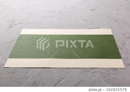 Perspective view of green tablecloth for food on cement background. Empty space for your design 102825578