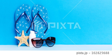 Beach accessories. Flip flops and starfish on colored background. Mock up with copy space Beach accessories. Flip flops and starfish on colored background. Mock up with copy space 102825688