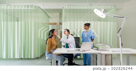 Young asian woman consulting about cosmetic surgeon and make botox injections on face for beauty procedures. Atmosphere at cosmetic surgery department in hospital clinic. 102826244