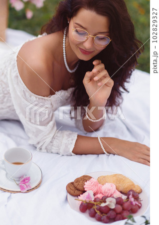 Romantic British Bride Enjoys Baked Treats in Park 102829327