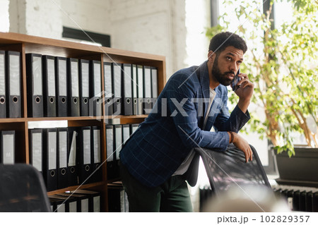 Multiracial man having call in his office. 102829357