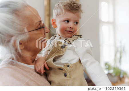Senior woman spending time with her little grandson. 102829361