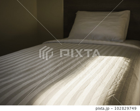Bedroom Bed duvet and pillow with morning sunlight Bedroom Bed duvet and pillow with morning sunlight 102829749