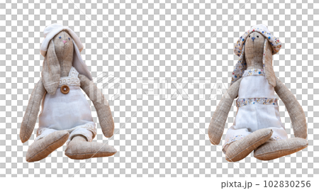 Tilda bunnies handmade in white clothes to decorate the house on a transparent background to decorate the apartment. Photo in high quality. PNG. Horizontal. 102830256