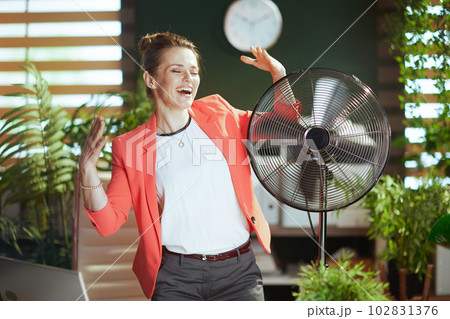 happy 40 years old woman employee in green office happy 40 years old woman employee in green office 102831376