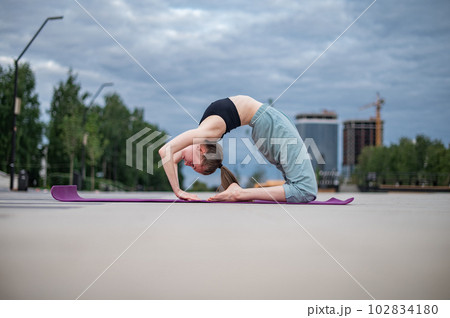 Girl practice yoga and meditation in the city. Girl practice yoga and meditation in the city. 102834180