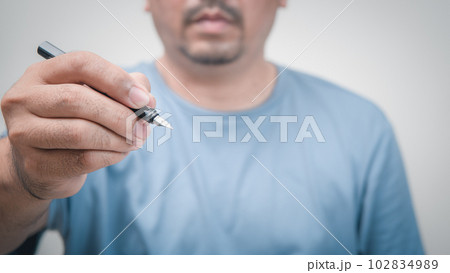 hand holding fountain pen on white background. hand holding fountain pen on white background. 102834989