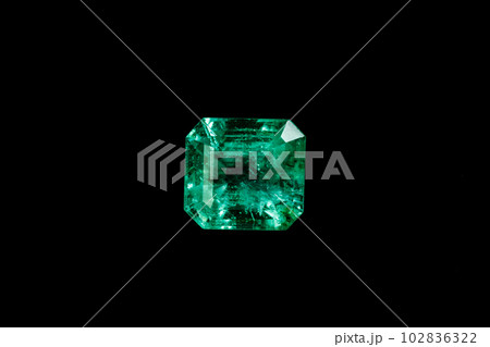 Macro mineral Emerald gemstone faceted on black background Macro mineral Emerald gemstone faceted on black background 102836322