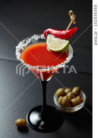 Bloody Mary cocktail with lime, red pepper, and green olives. Bloody Mary cocktail with lime, red pepper, and green olives. 102836569