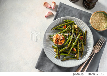 Roasted garlic green beans in grey plate. Top view, copy space Roasted garlic green beans in grey plate. Top view, copy space 102837035