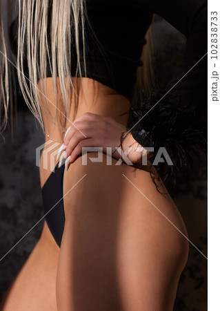 Slender narrow waist.Close up strong abdominal muscles of a young sporty woman. Slender narrow waist.Close up strong abdominal muscles of a young sporty woman. 102838733