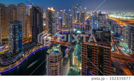 View of various skyscrapers in tallest recidential block in Dubai Marina aerial day to night timelapse 102839877