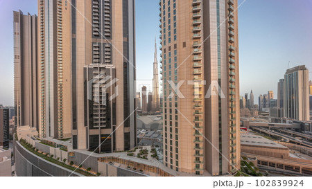 Tallest skyscrapers in downtown dubai located on bouleward street near shopping mall aerial night to day timelapse. Tallest skyscrapers in downtown dubai located on bouleward street near shopping mall aerial night to day timelapse. 102839924