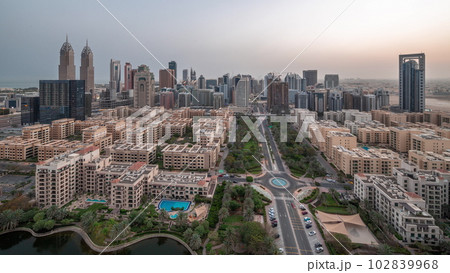 Skyscrapers in Barsha Heights district and low rise buildings in Greens district aerial night to day timelapse. Skyscrapers in Barsha Heights district and low rise buildings in Greens district aerial night to day timelapse. 102839968